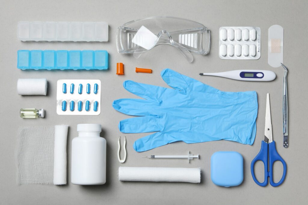 First aid kit supplies on gray background