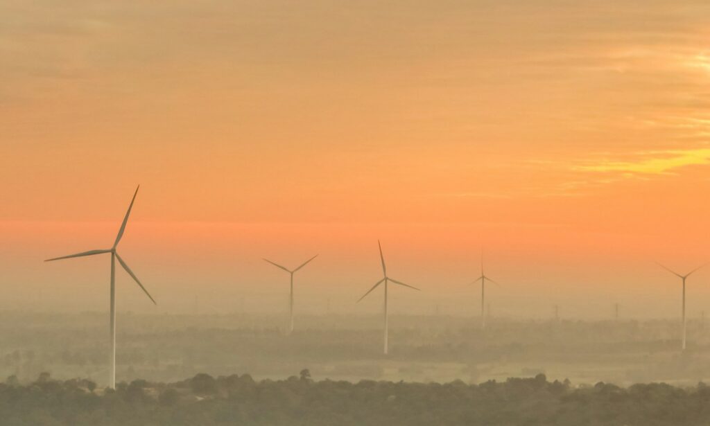 Landscape wind farm with sunrise sky. Sustainable renewable energy. Wind power for sustainability.